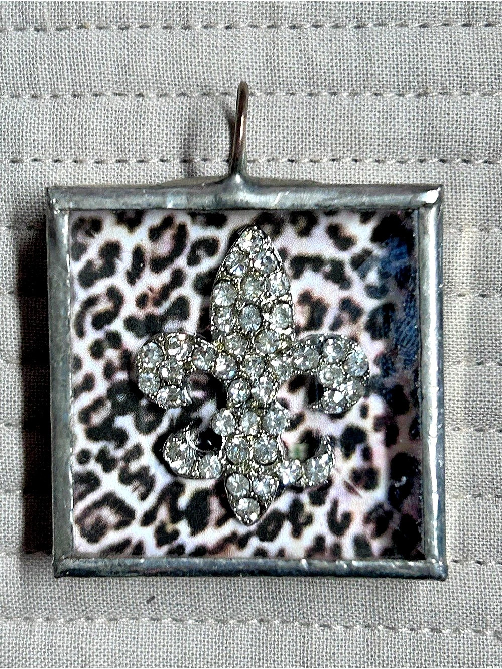 Silver-tone square shadow box charm pendant with a rhinestone embellished Fleur-